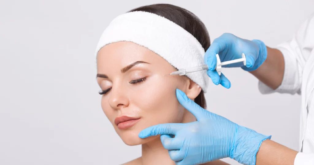 A woman receiving a Botox injection from a medical professional in Evans, GA.